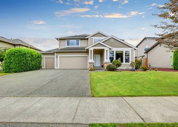Neat beige home with two garage spaces and large concrete driveway. Northwest, USA